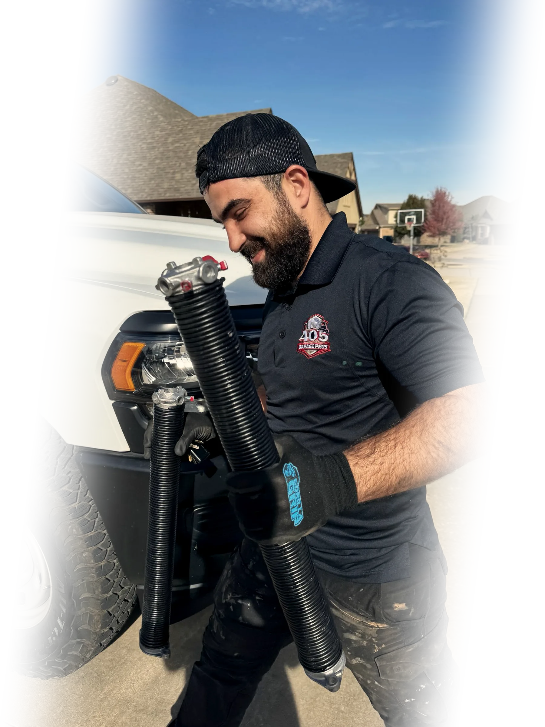 405 Garage Pros technician replacing a garage door torsion spring on a residential garage door in Edmond, Oklahoma